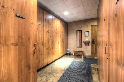a hallway with wooden walls and a bench in a room at Timbers 3080 in Keystone