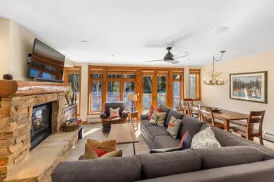 a living room with a couch and a fireplace at Timbers 3080 in Keystone