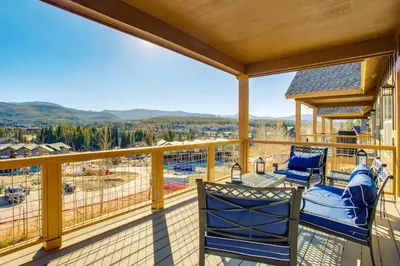 a balcony with two chairs and a view of a construction at Less Than 5 Mi to Winter Park Family Base Camp with Hot Tub in Fraser