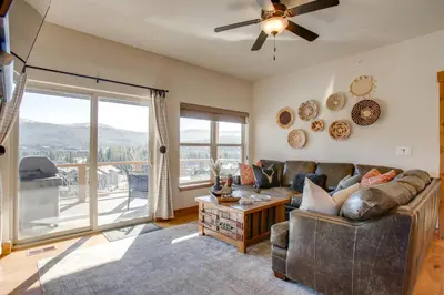 a living room with a couch and a large window at Less Than 5 Mi to Winter Park Family Base Camp with Hot Tub in Fraser