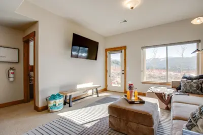 a living room with a couch and a table at Less Than 5 Mi to Winter Park Family Base Camp with Hot Tub in Fraser