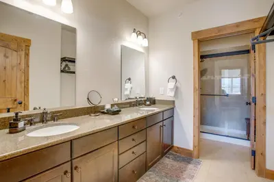 a bathroom with two sinks and a large mirror at Less Than 5 Mi to Winter Park Family Base Camp with Hot Tub in Fraser