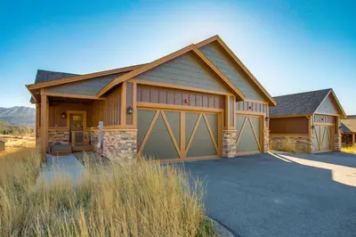 a house with two garage doors on a driveway at Less Than 5 Mi to Winter Park Family Base Camp with Hot Tub in Fraser