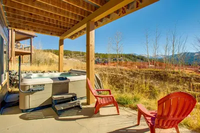 a porch with two chairs and a sink on a house at Less Than 5 Mi to Winter Park Family Base Camp with Hot Tub in Fraser
