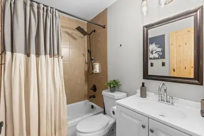 a bathroom with a toilet and a sink and a shower at Mountain View Retreat- Private Hot Tub & Views in Bailey