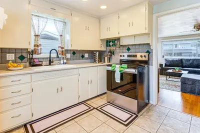 a kitchen with white cabinets and an oven at Walk to Old Town Lafayette! Cozy Couples Escape in Lafayette