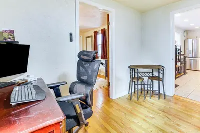 an office with a desk with a computer and a stool at Walk to Old Town Lafayette! Cozy Couples Escape in Lafayette