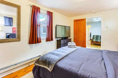 a bedroom with a bed and a television at Walk to Old Town Lafayette! Cozy Couples Escape in Lafayette
