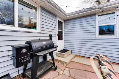 a barbecue grill sitting outside of a house at Walk to Old Town Lafayette! Cozy Couples Escape in Lafayette