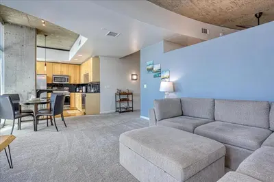 a living room with a couch and a table at Sunset View in Denver