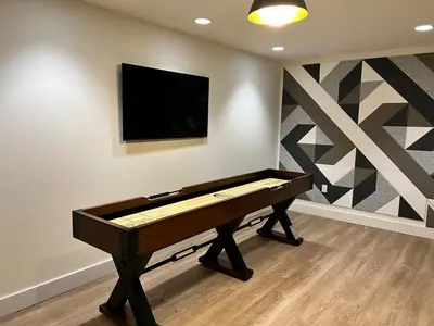 a pool table in a room with a tv on a wall at Sunset View in Denver