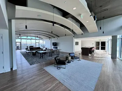 a living room with a table and chairs in a building at Sunset View in Denver