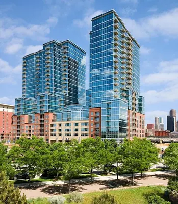 a group of tall buildings in a city with trees at Sunset View in Denver