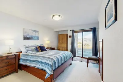 a bedroom with a bed and a dresser and a window at Granby Vista Getaway in Granby