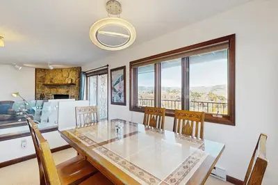 a dining room with a glass table and chairs at Granby Vista Getaway in Granby
