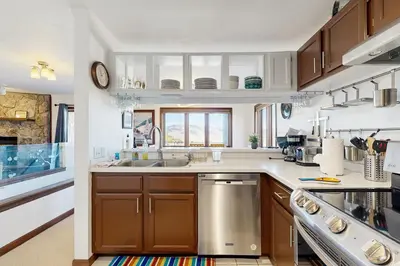 a kitchen with wooden cabinets and a sink at Granby Vista Getaway in Granby