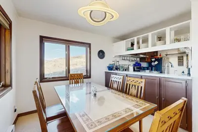 a kitchen with a glass table and chairs at Granby Vista Getaway in Granby