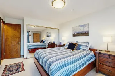a bedroom with two beds and a mirror at Granby Vista Getaway in Granby