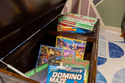 a pile of video games on a table at Movie Theater Game Console Arcade Fire Pit BBQ in Westminster