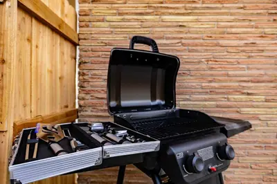 a bbq grill sitting next to a brick wall at Movie Theater Game Console Arcade Fire Pit BBQ in Westminster