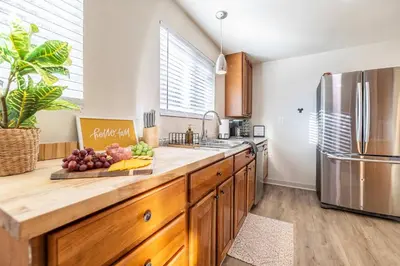 a kitchen with a counter with fruit on a cutting board at Movie Theater Game Console Arcade Fire Pit BBQ in Westminster
