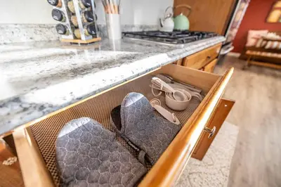 a drawer in a kitchen with shoes in it at Movie Theater Game Console Arcade Fire Pit BBQ in Westminster