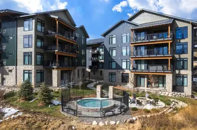 an image of an apartment complex with a pool at Timber Fox 2207 condo in Winter Park