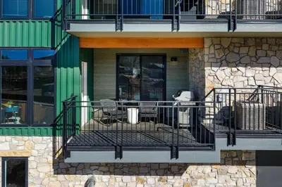a balcony with a table and chairs on a building at Timber Fox 2207 condo in Winter Park