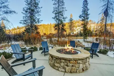 a fire pit with chairs and trees in the background at Timber Fox 2207 condo in Winter Park