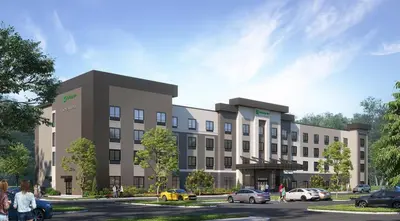 a rendering of a building with cars parked in a parking lot at Holiday Inn & Suites Commerce City - Denver Airport by IHG in Commerce City