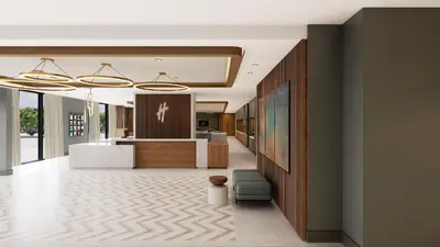 an office lobby with a reception desk and a counter at Holiday Inn & Suites Commerce City - Denver Airport by IHG in Commerce City