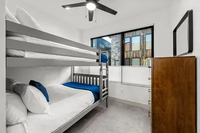 a bedroom with a bunk bed with a ceiling fan at 50 East 6th Ave A3 in Silverthorne