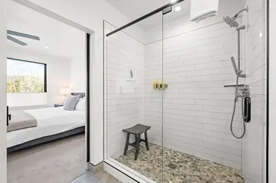 a glass shower in a bedroom with a bed at 50 East 6th Ave A3 in Silverthorne