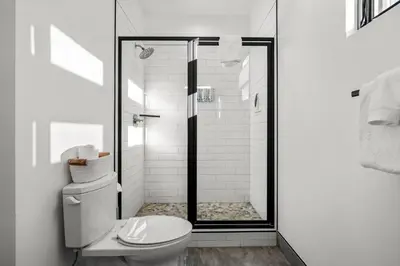 a white bathroom with a shower with a toilet at 50 East 6th Ave A3 in Silverthorne