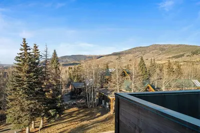 an aerial view of a house with mountains in the background at 50 East 6th Ave A3 in Silverthorne