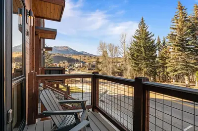 a balcony with two chairs and a view of a mountain at 50 East 6th Ave A3 in Silverthorne
