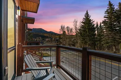 a balcony with two chairs and a view of the mountains at 50 East 6th Ave A3 in Silverthorne