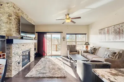 a living room with a couch and a fireplace at Lookout Point in Fraser