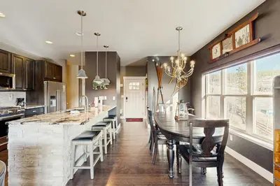 a kitchen with a table and chairs and a dining room at Lookout Point in Fraser