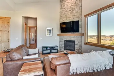 a living room with a couch and a fireplace at 5 Mi to Winter Park Skiing and Dtwn Mtn-View Condo in Fraser
