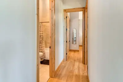 a hallway with a door leading into a room at 5 Mi to Winter Park Skiing and Dtwn Mtn-View Condo in Fraser