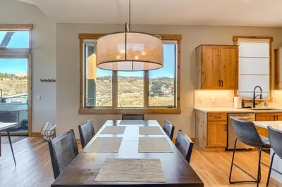 a dining room with a table and a large window at 5 Mi to Winter Park Skiing and Dtwn Mtn-View Condo in Fraser