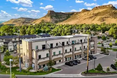 an apartment building in front of a mountain at Heart of Gold-en - Walk Everywhere -Close to Red Rocks in Golden