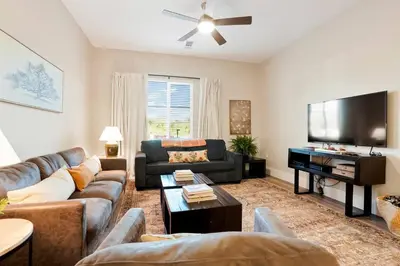 a living room with a couch and a flat screen tv at Heart of Gold-en - Walk Everywhere -Close to Red Rocks in Golden