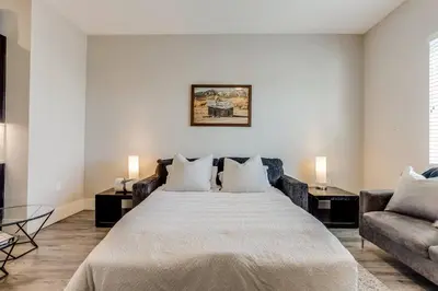 a bedroom with a large bed and a couch at Heart of Gold-en - Walk Everywhere -Close to Red Rocks in Golden
