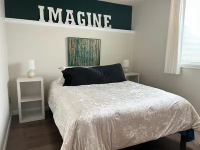 a bedroom with a bed and a sign on the wall at Longmont board games, beds, and boats - 4BR in Longmont