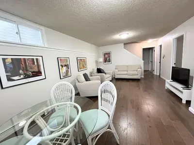 a living room with a glass table and chairs at Longmont board games, beds, and boats - 4BR in Longmont
