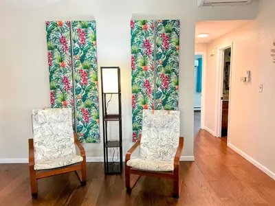 two chairs in front of a wall with a mural of flowers at Longmont board games, beds, and boats - 4BR in Longmont