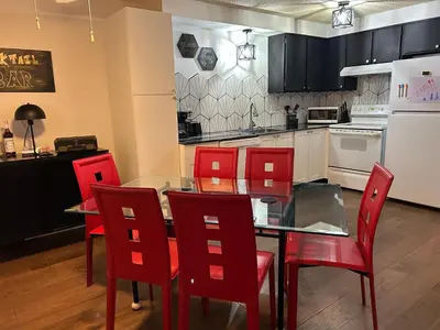 a kitchen with a dining table and red chairs at Longmont board games, beds, and boats - 2BR in Longmont