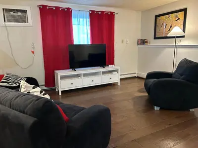 a living room with two couches and a flat screen tv at Longmont board games, beds, and boats - 2BR in Longmont